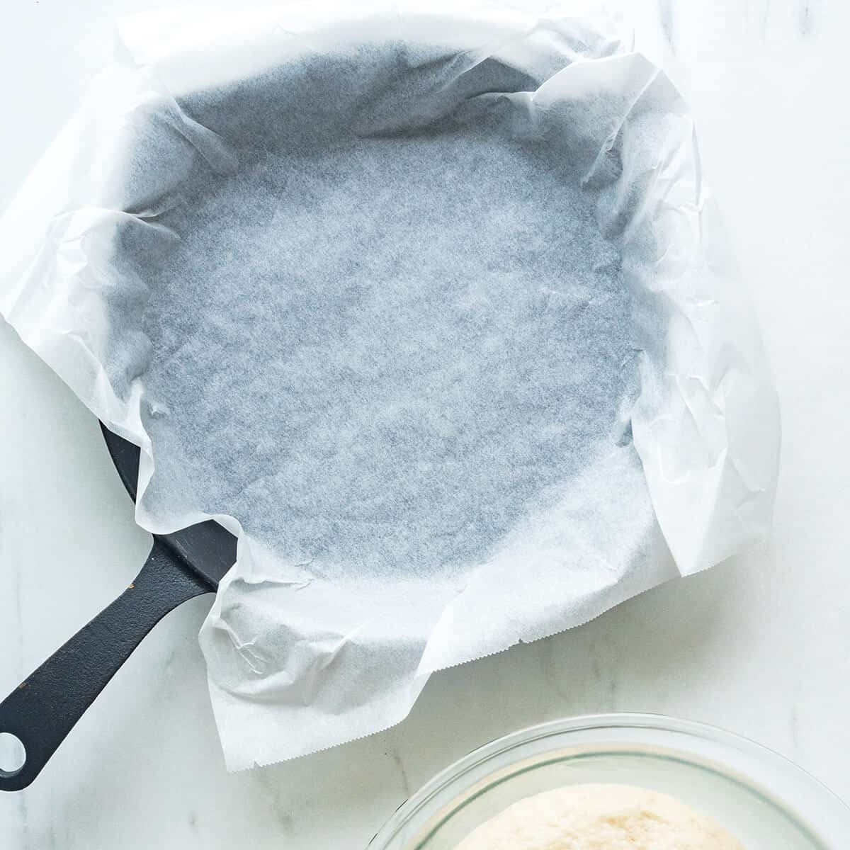 A skillet lined with parchment paper.