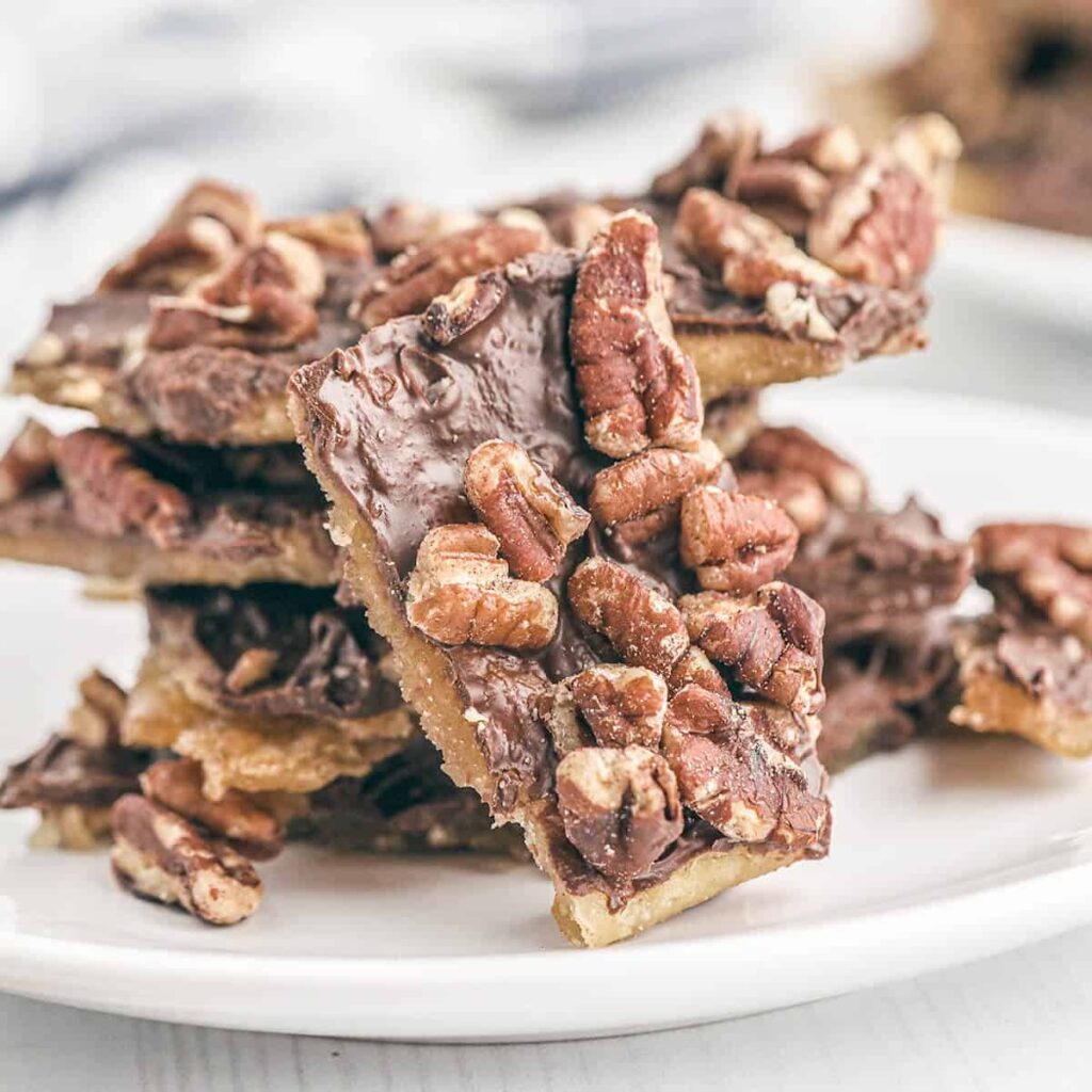 Saltine cracker toffee on a white serving plate.