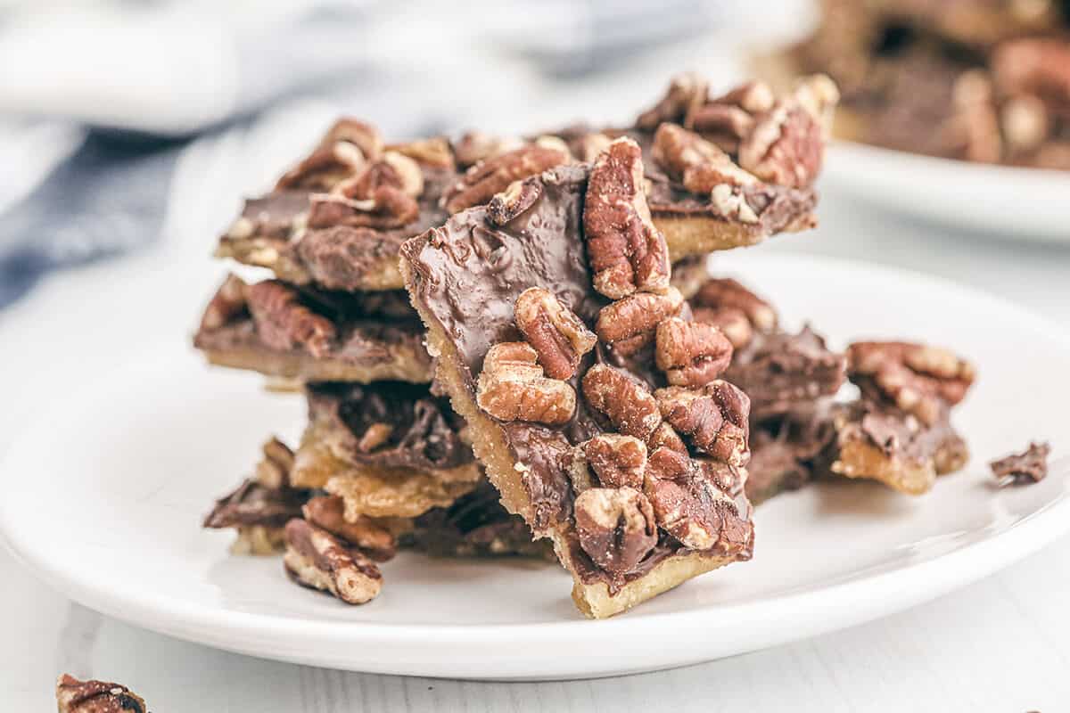 Saltine cracker toffee on a white serving plate.