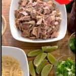 Overhead view of a white bowl filled with chopped turkey, a bowl of cooked noodles, sliced green onions, lime wedges, cilantro, and red pepper flakes on a wooden surface. Text reads “Asian Inspired Turkey Noodle Bowl.”.