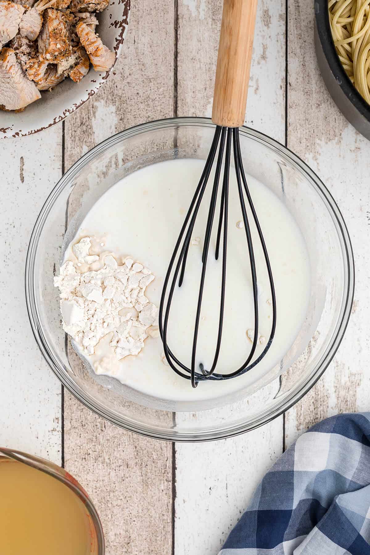 Whisking together the flour and milk.