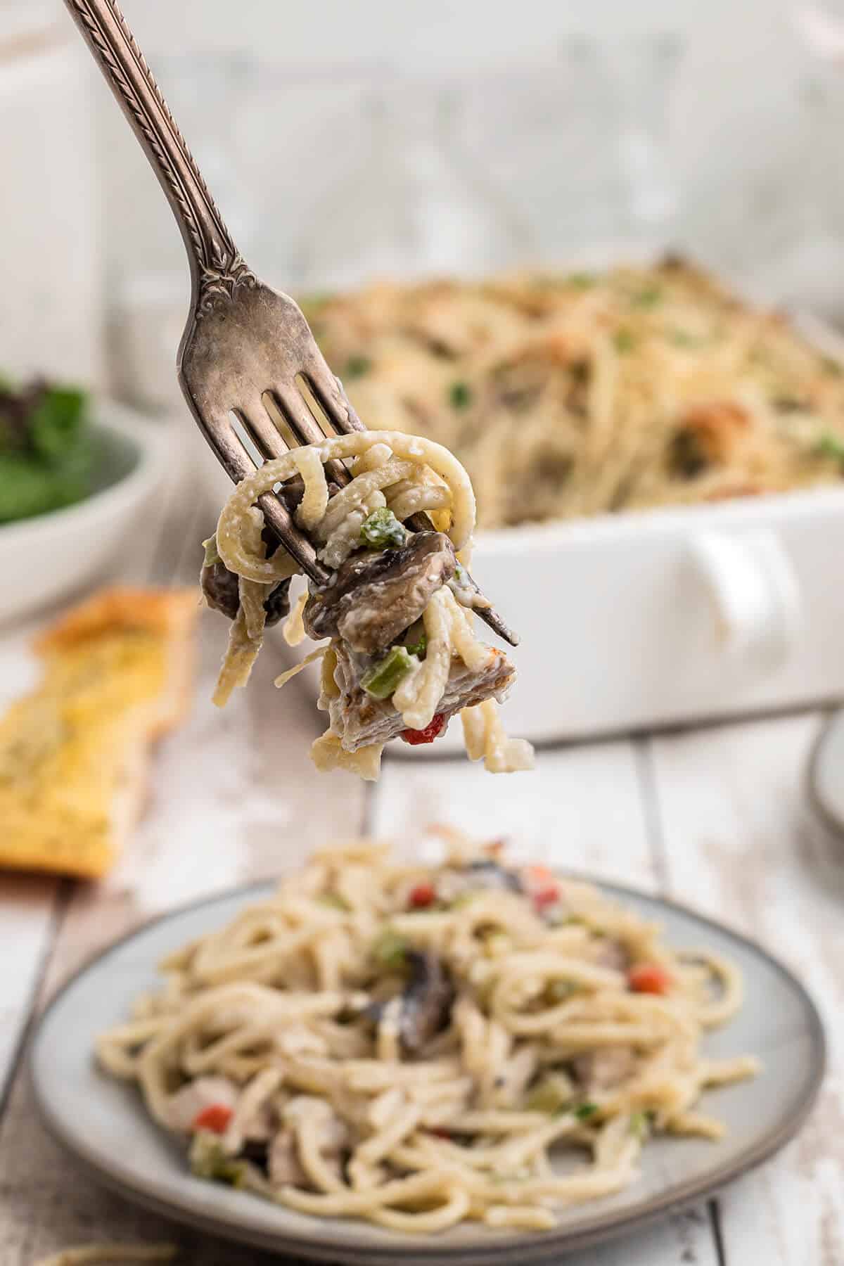 A single fork full of turkey tetrazzini casserole.