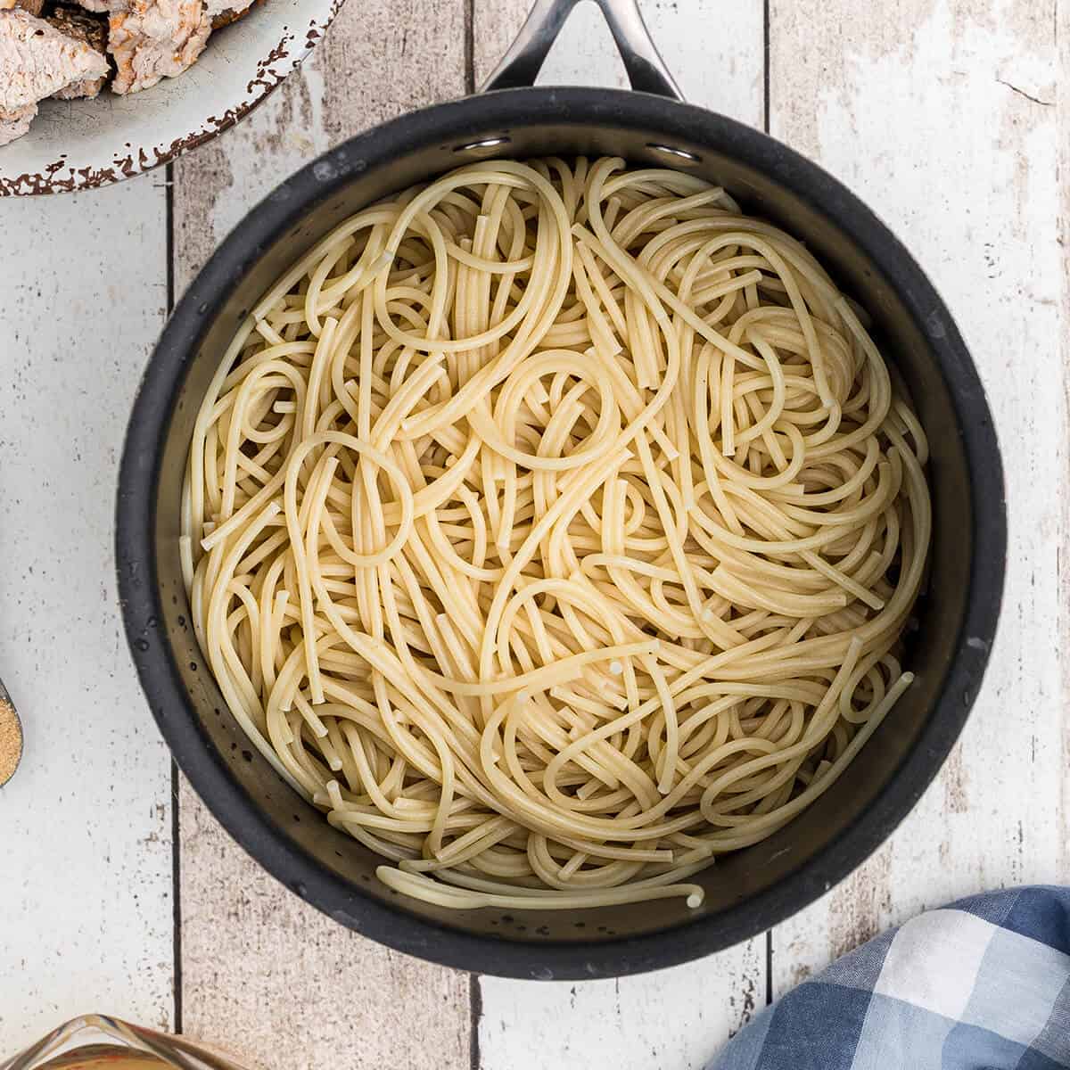 Turkey Tetrazzini Cooked spaghetti in a large pot.