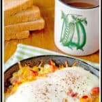Hash Brown Omelet Skillets on a kitchen towel with a cup of coffee in the background. Text overlay for pinning.