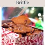 A gift box filled with broken pieces of peanut brittle.