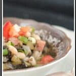 A bowl of Beans and Greens Soup with a spoon in the foreground.