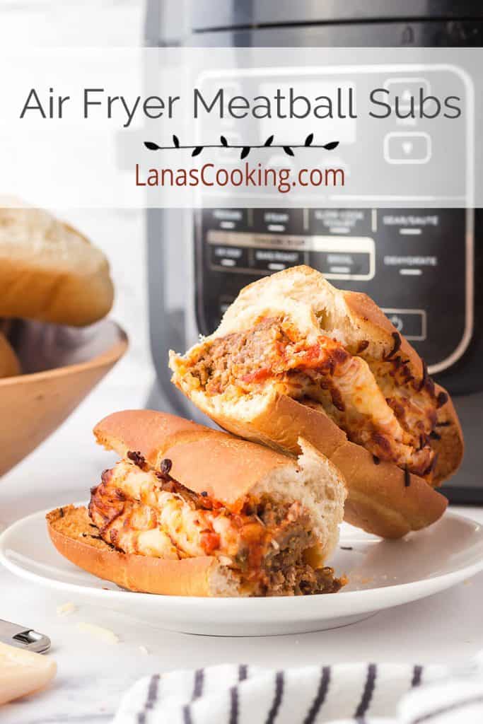 A finished meatball sub split in half on a serving plate.