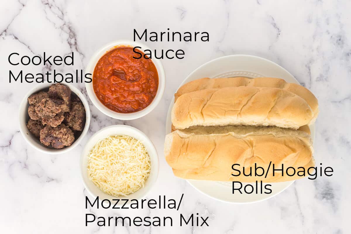 Photo of hoagie rolls, marinara sauce, cheese, and meatballs.
