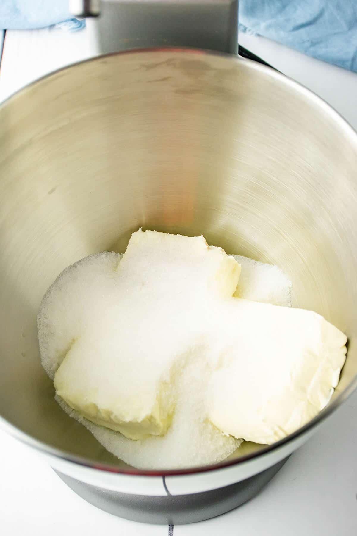 Cream cheese and sugar in a mixing bowl.