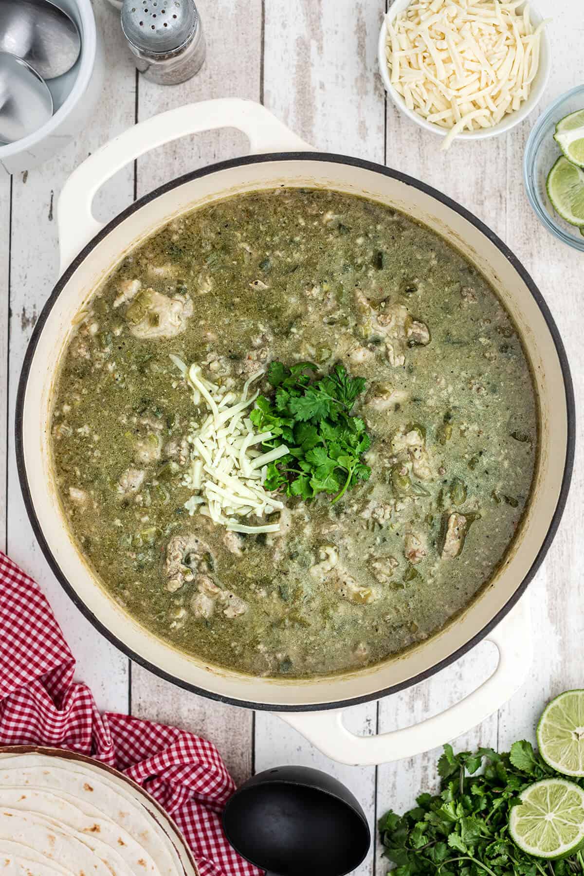 Finished chili verde garnished with cheese and cilantro.