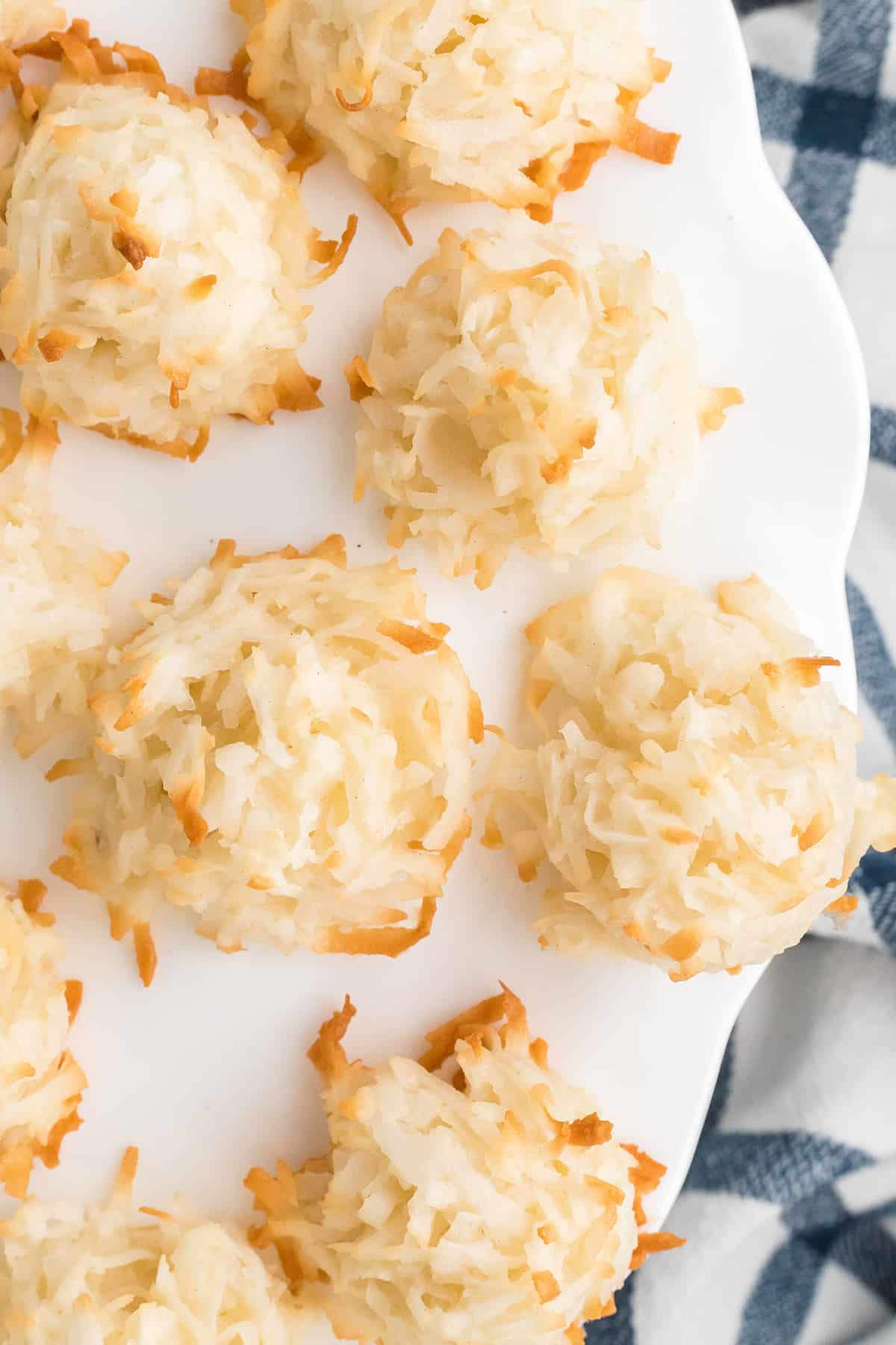 Coconut macaroons on a white pedestal.