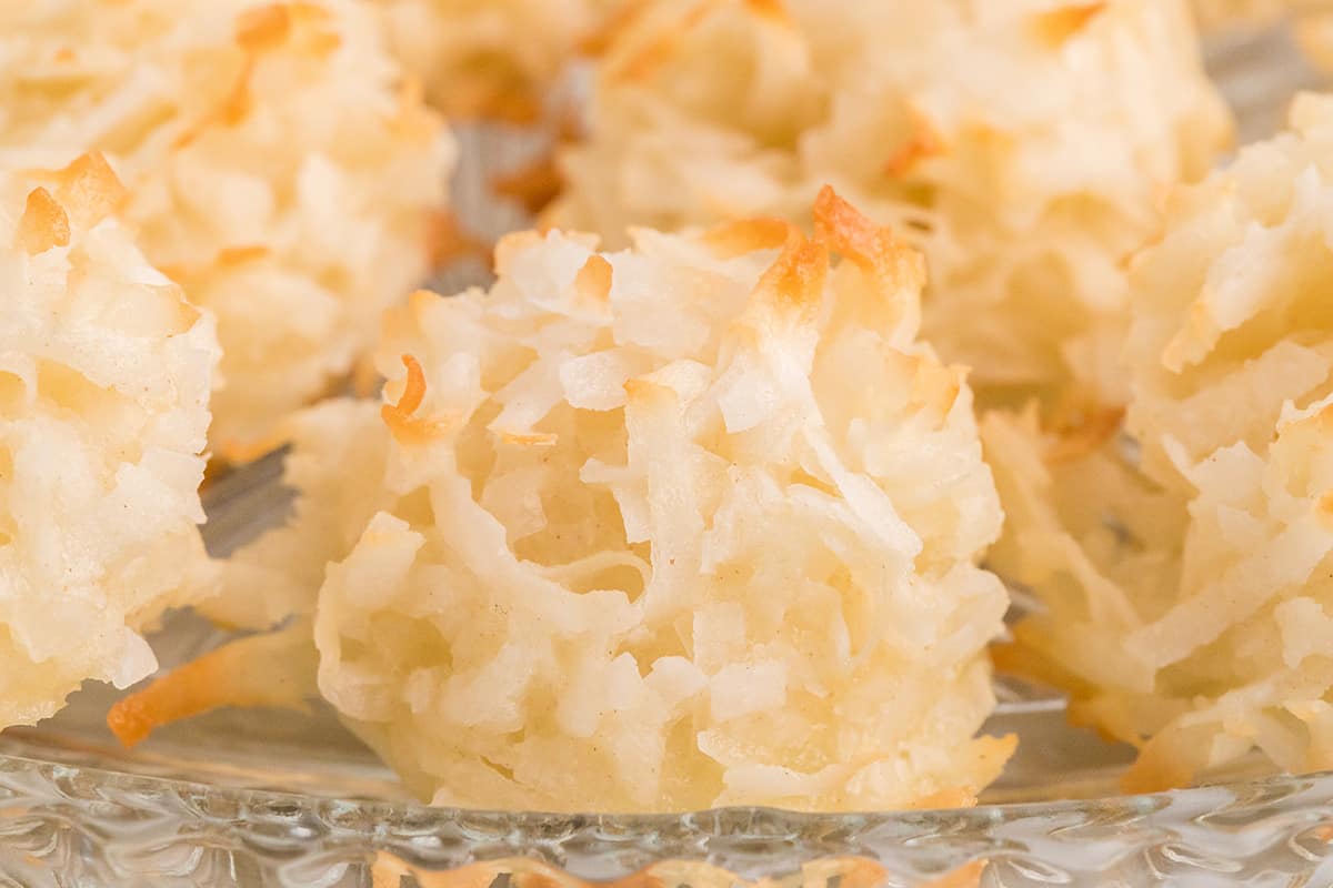 Close-up of coconut macaroons, showing their golden, crispy exterior and shredded coconut texture.