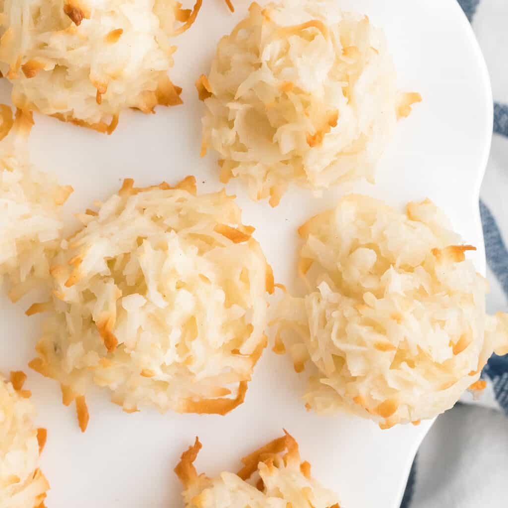 Coconut macaroons on a white pedestal.