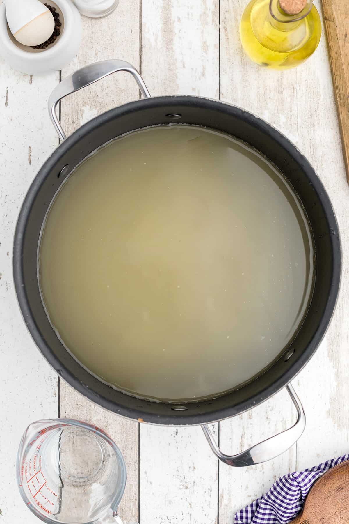 Stock heating in a pan.