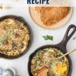 Two small skillets with herbed baked eggs, toast, and a fork on a white table.