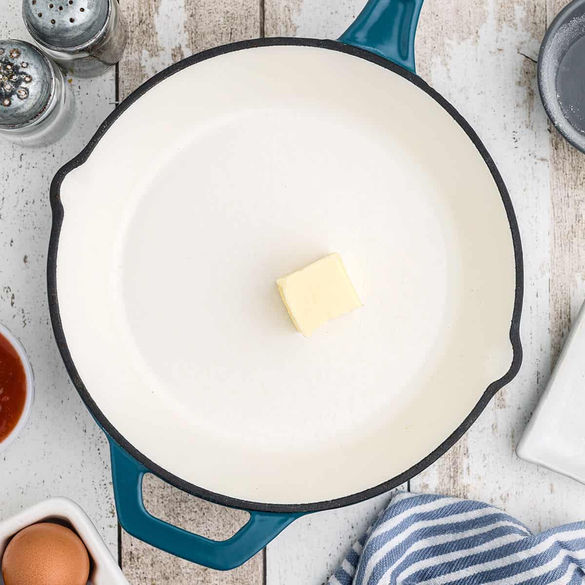 A skillet with butter in the bottom.