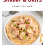 Bowl of shrimp and grits topped with green onions on a white surface, labeled Southern Shrimp & Grits..