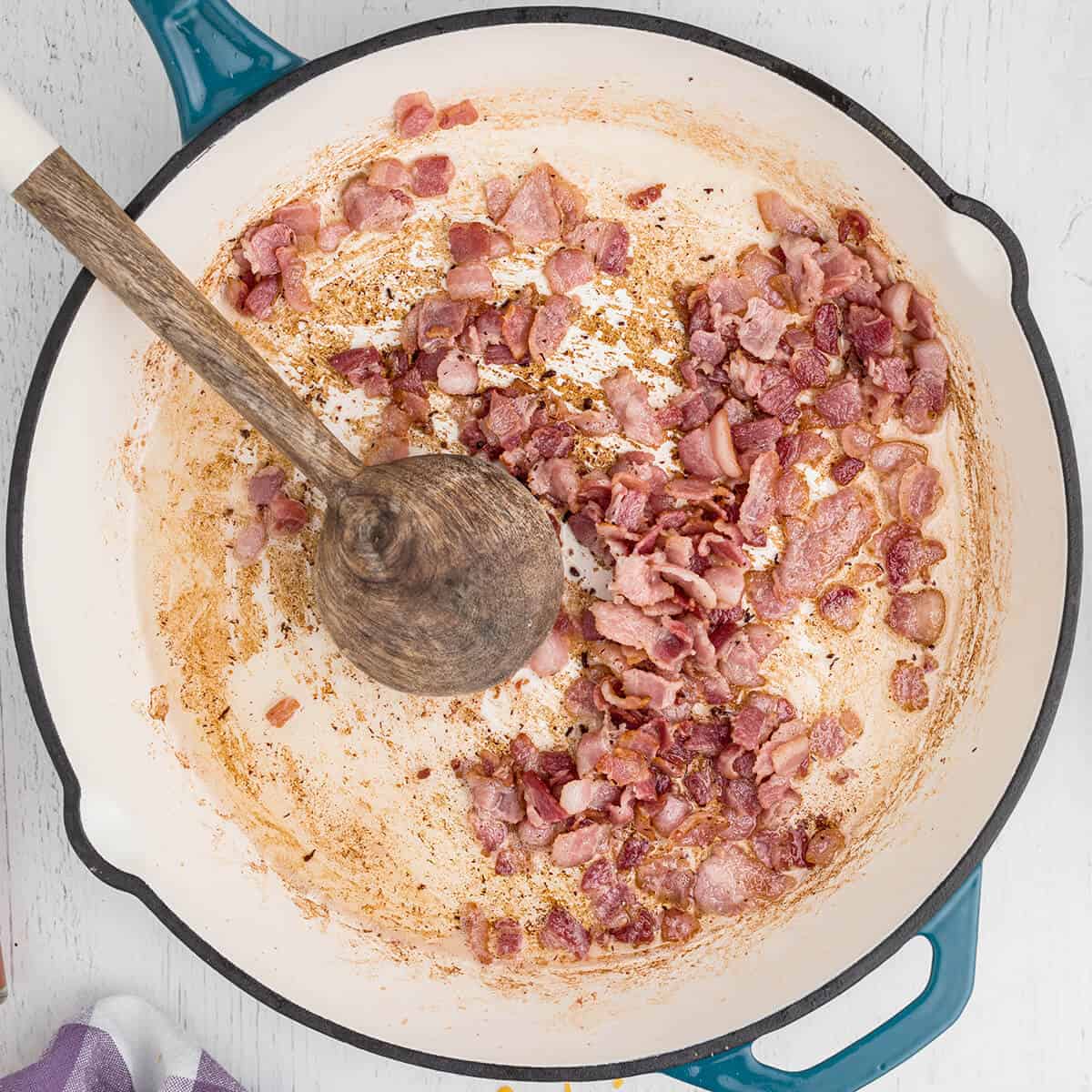 Bacon cooking in a skillet.