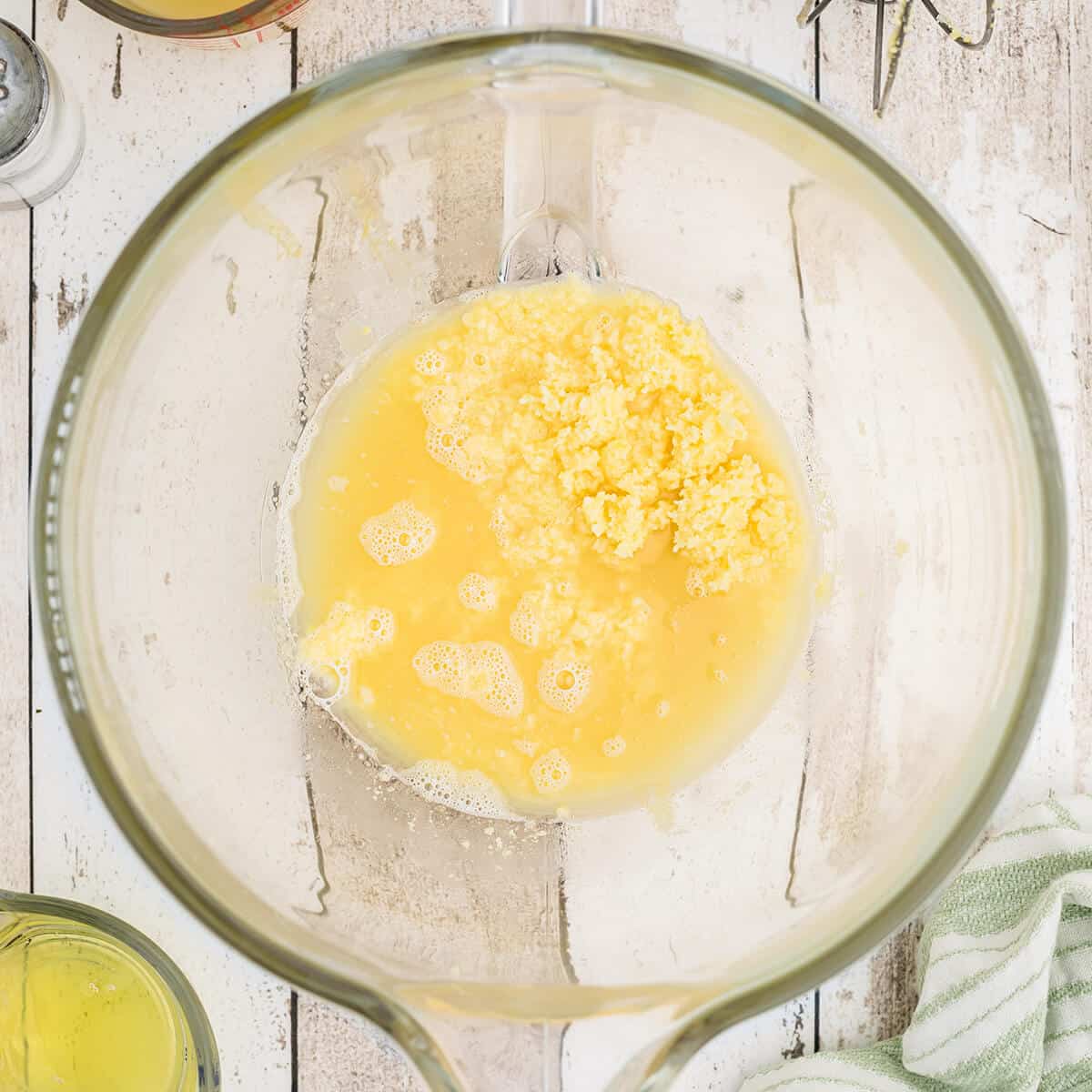 Adding pineapple juice to egg yolks and sugar.