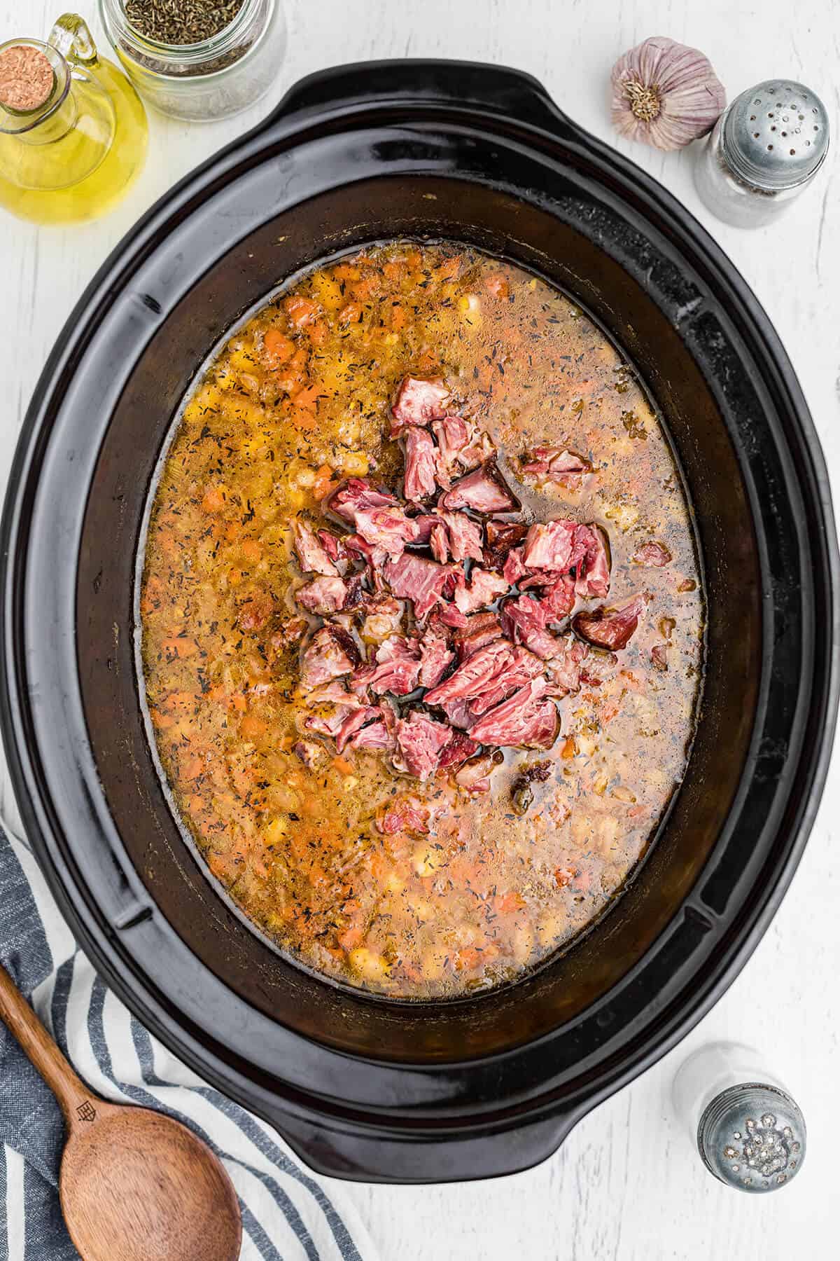 Meat from ham hocks added back to slow cooker.