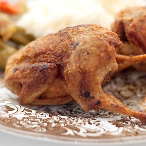 Fried quail on a vintage dinner plate.