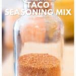 A glass jar filled with homemade taco seasoning mix, labeled as a great pantry item.
