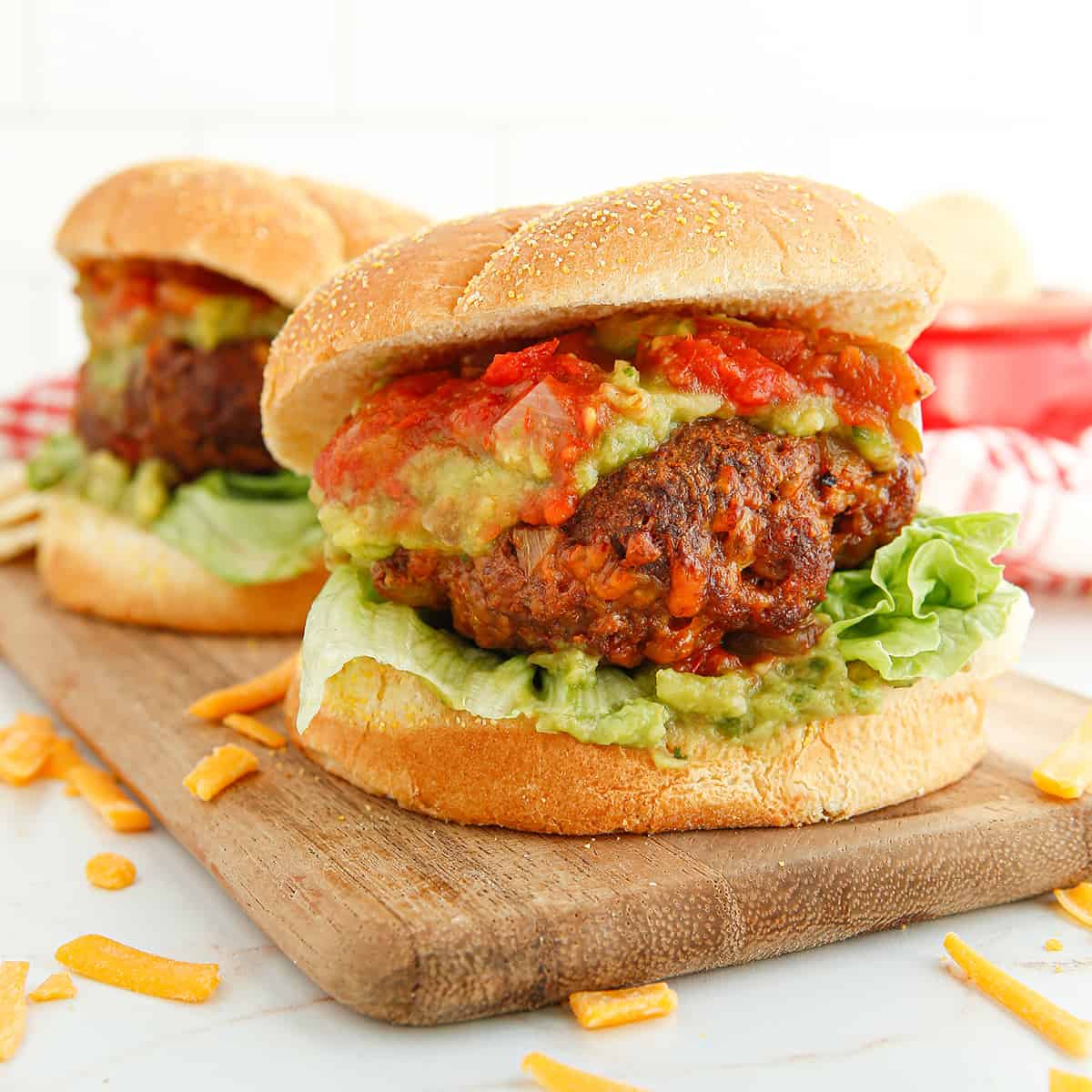 Finished taco burger on a wooden serving board.