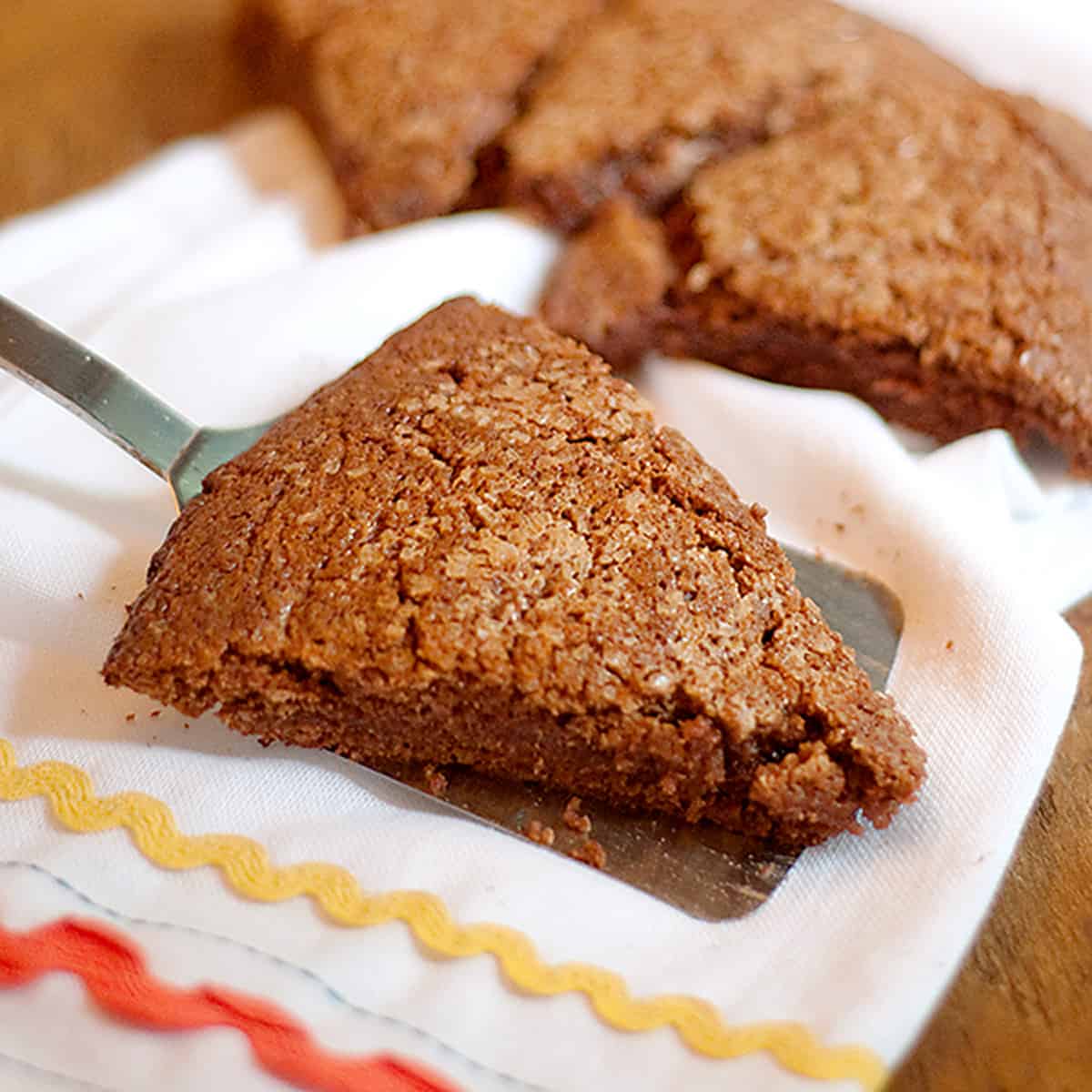 A chocolate scone on a spatula.