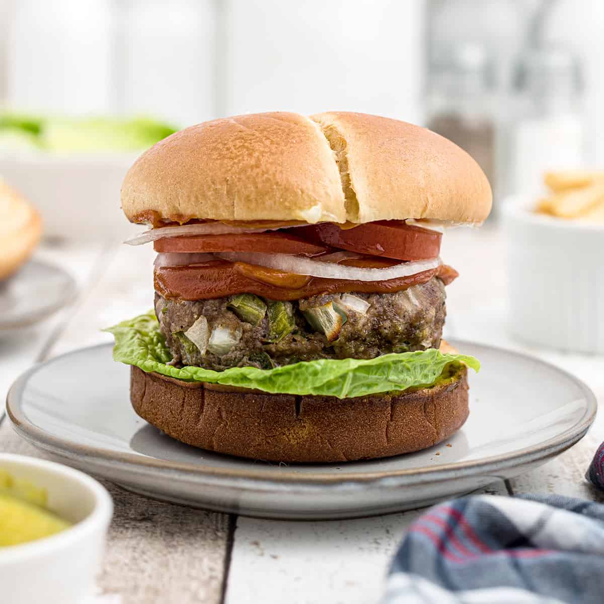 A meatloaf burger on a white serving plate.