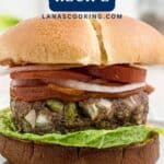 A meatloaf burger with lettuce, onions, and tomato on a bun, with text Meatloaf Burgers Recipe.