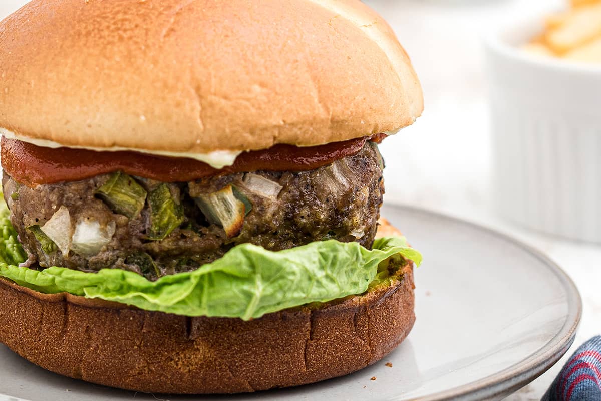 A meatloaf burger on a white serving plate.