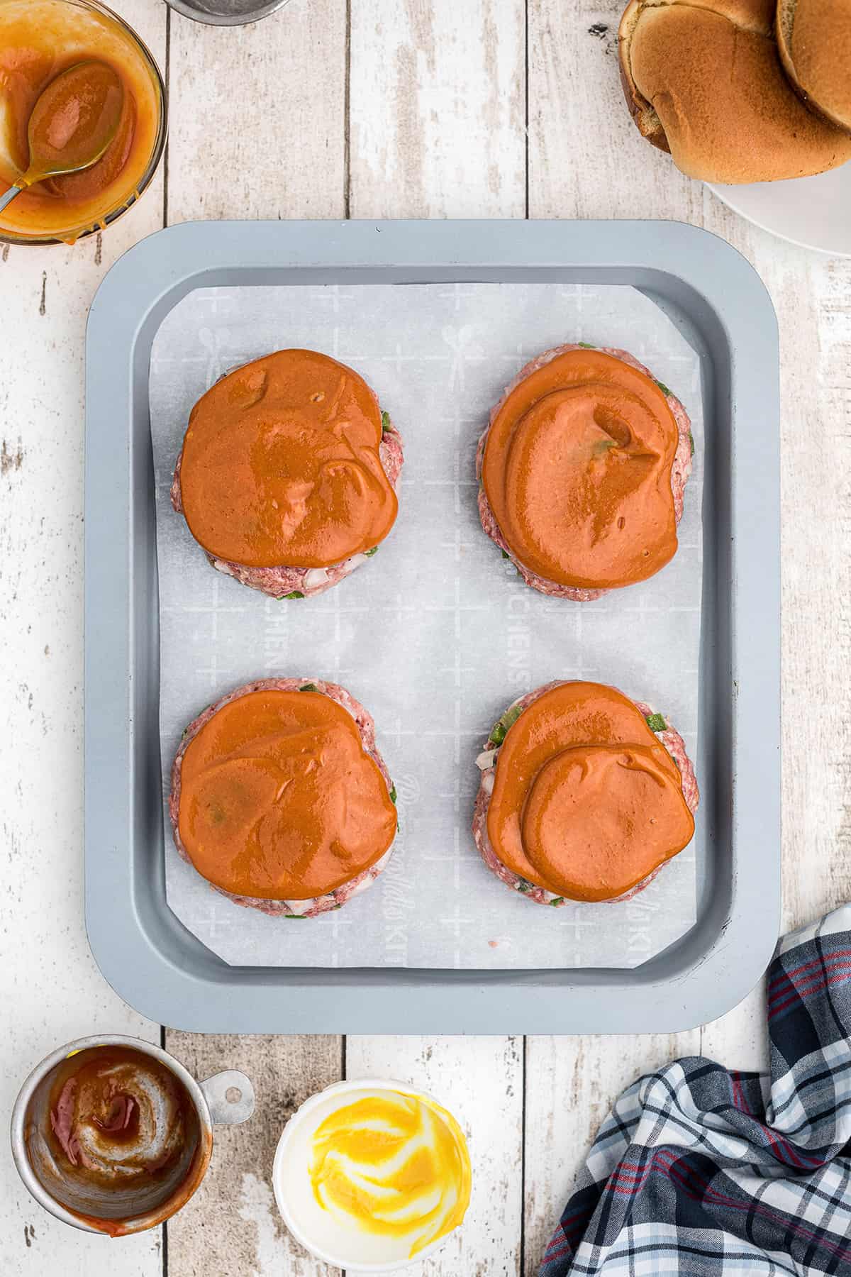 Burgers topped with ketchup-mustard mix.