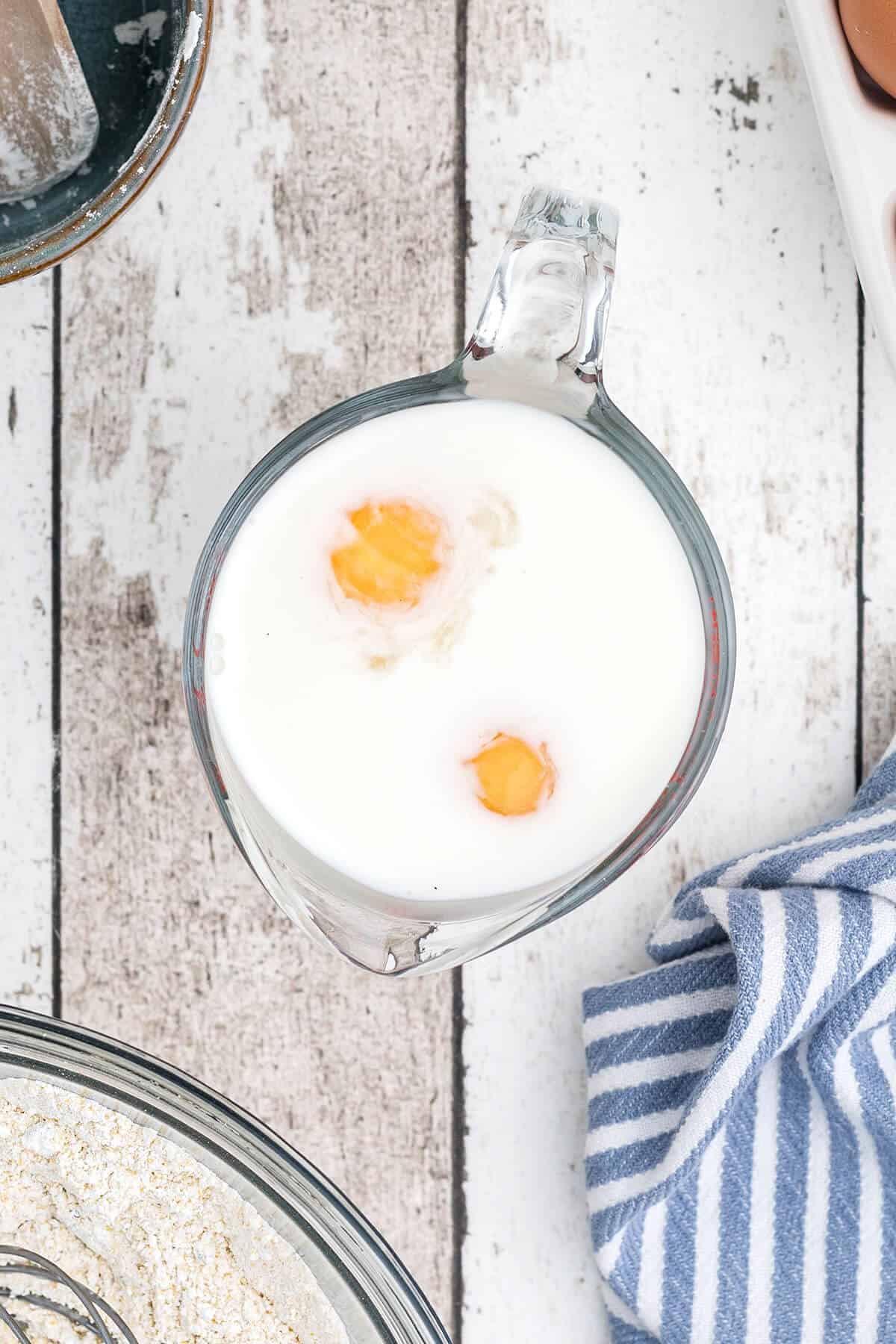 Eggs and buttermilk in measuring cup.
