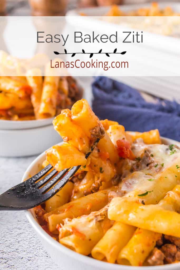 A serving of baked ziti in a white dish.