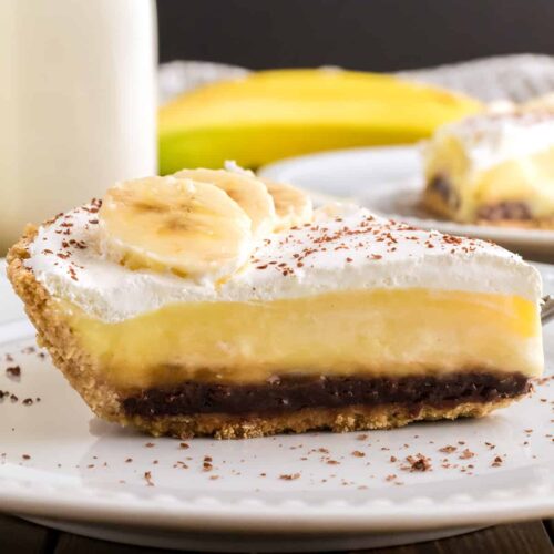 A slice of banana fudge pie on a white plate.