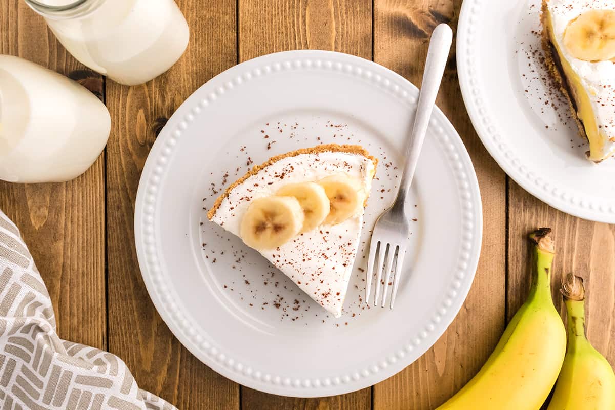 A slice of banana fudge pie on a white plate.