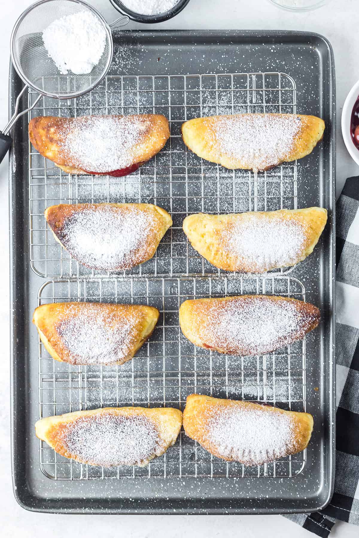 Finished fried hand pies on a wire rack.