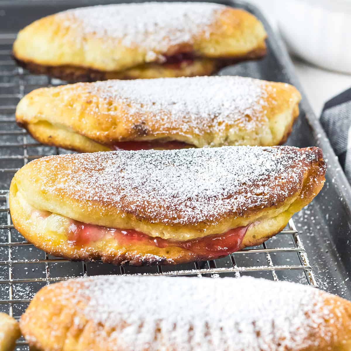 Finished fried hand pies on a wire rack.