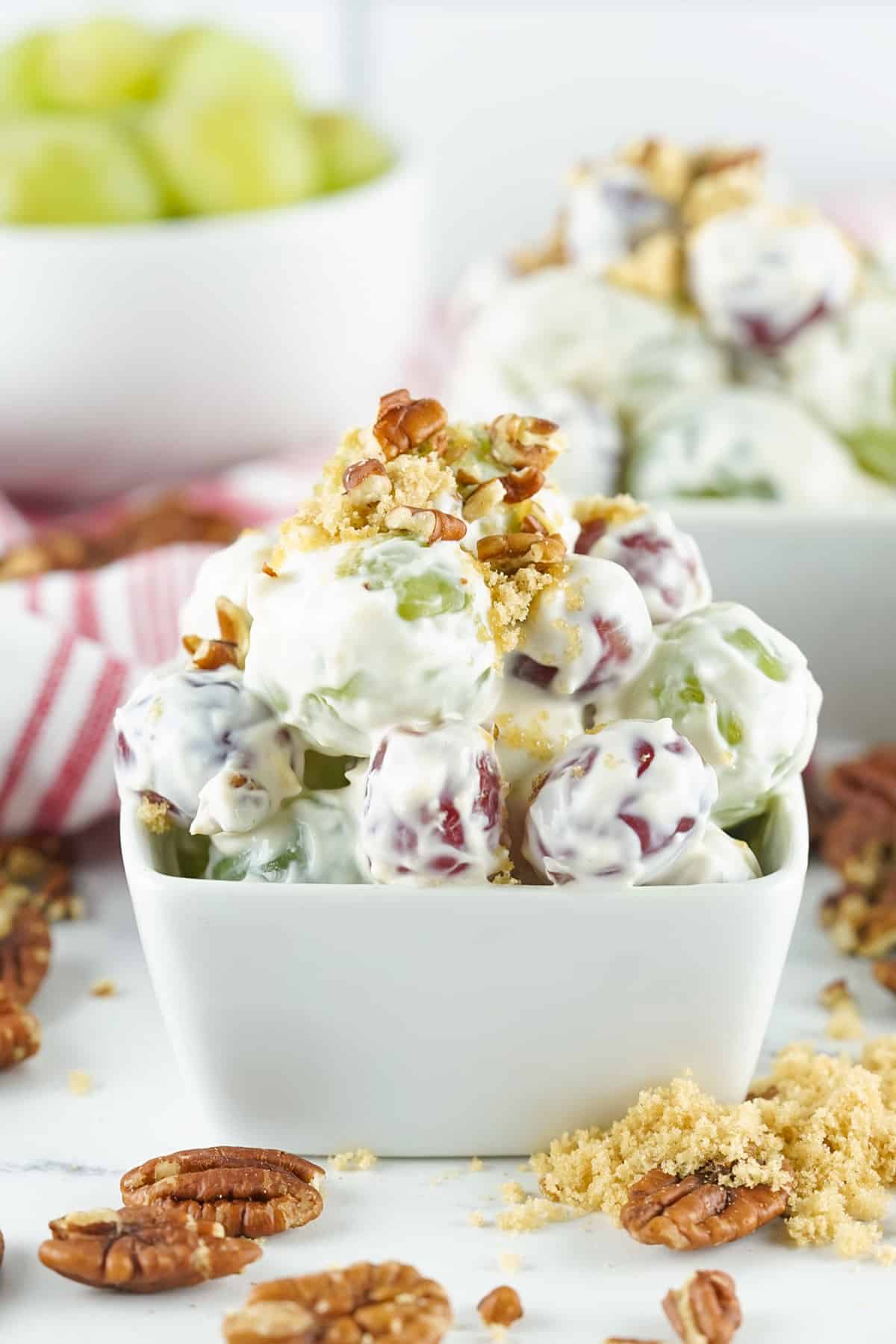 A serving of grape salad in a white bowl.