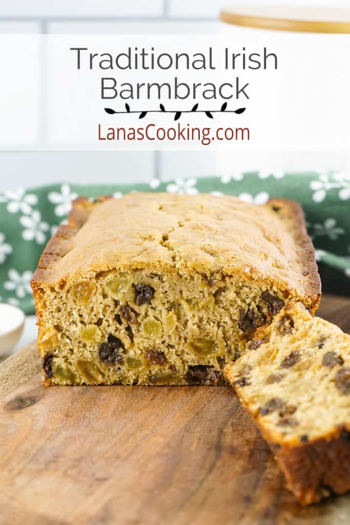 A loaf of Irish barmbrack on a wooden cutting board.