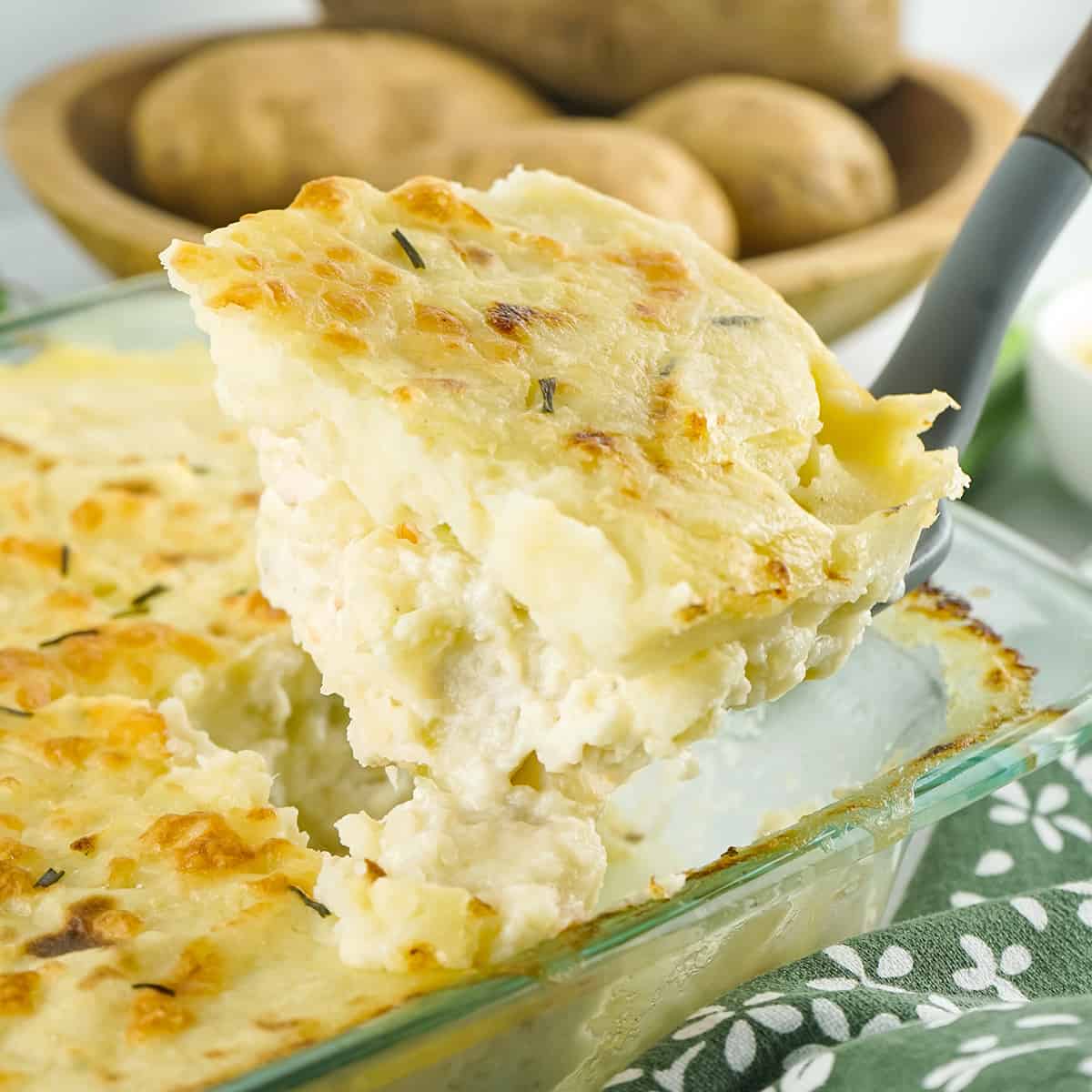 A spoon holding a serving of fish pie.