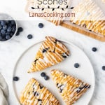Lemon blueberry scones on a white serving plate.