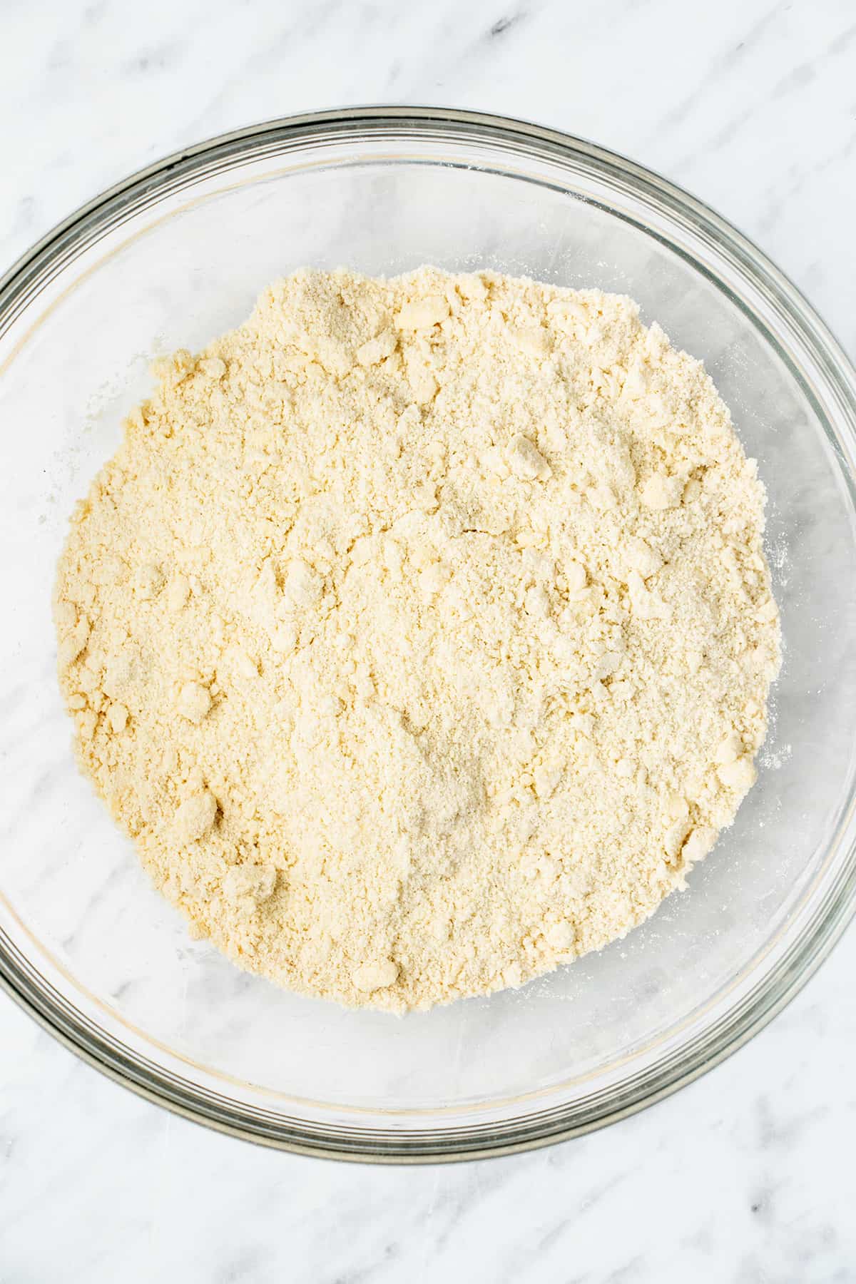 Flour and butter cut together in a mixing bowl.