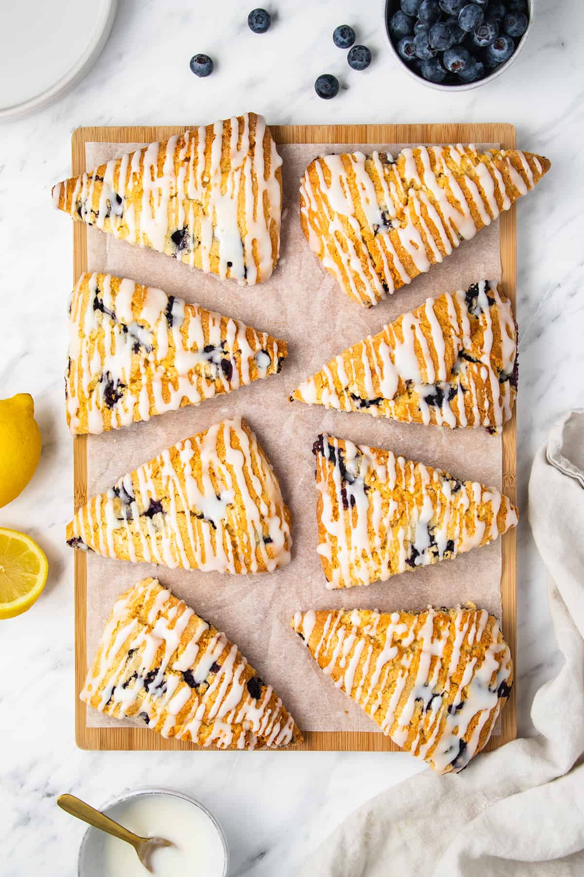 Lemon blueberry scones on a wooden board.