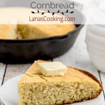 A slice of cornbread topped with a pat of butter.