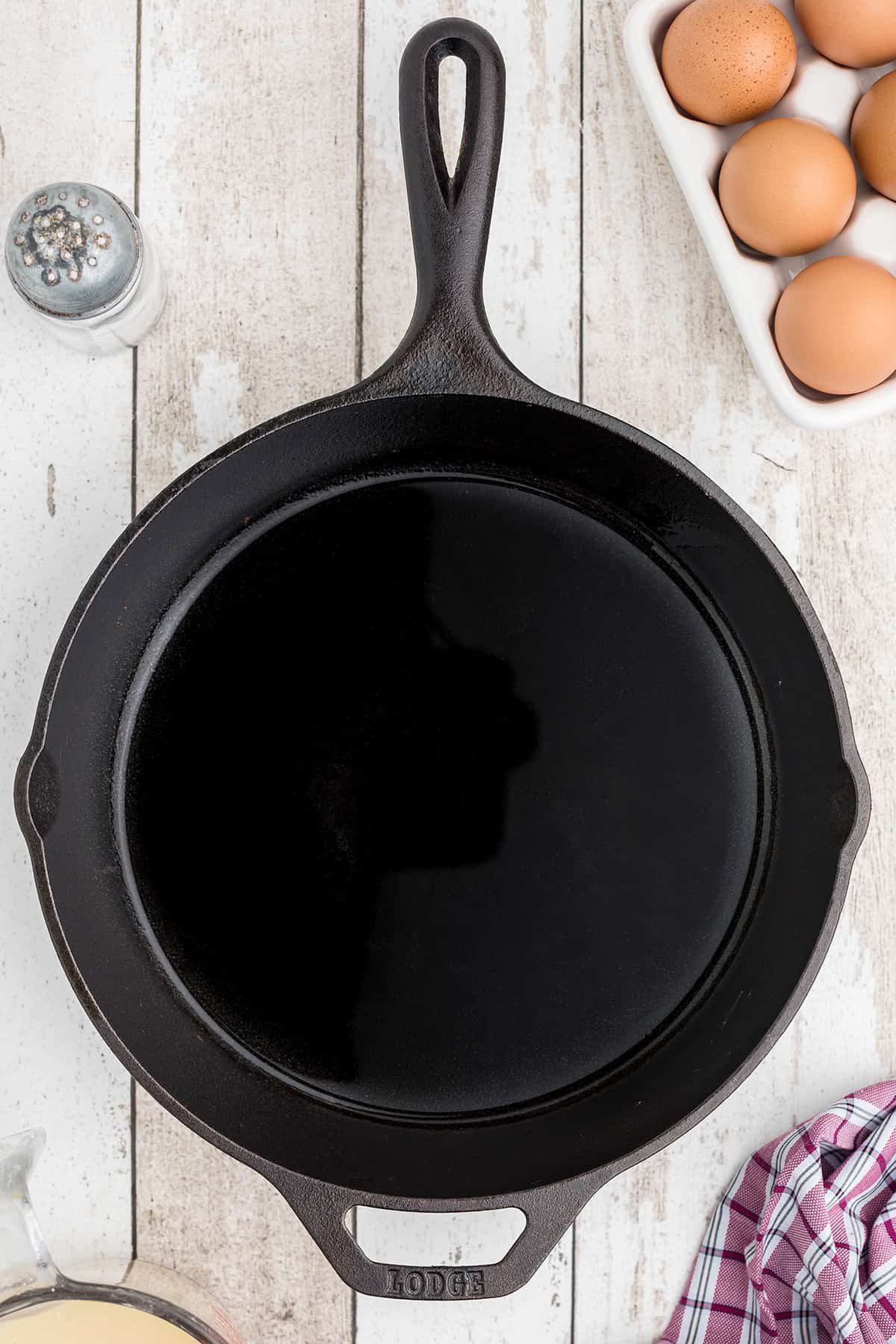 A cast iron skillet with oil in the bottom.