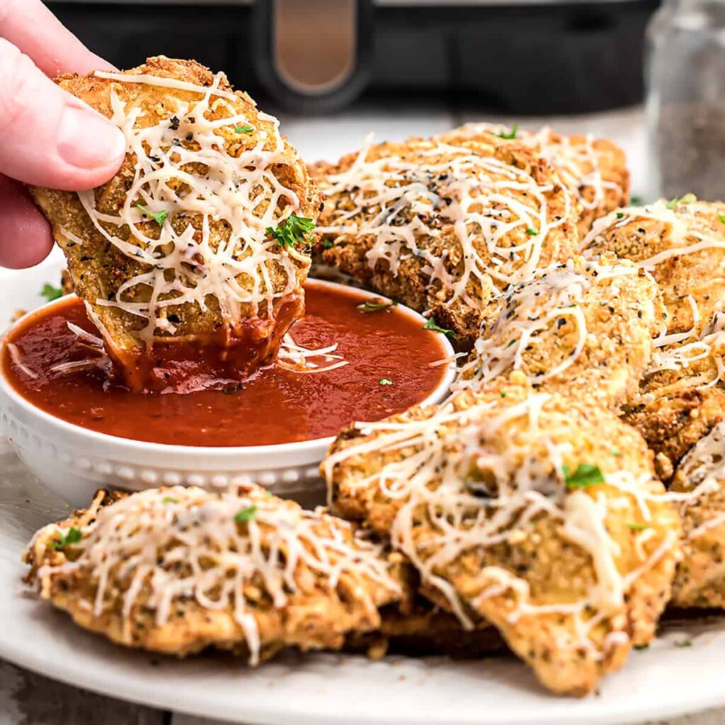 Air fryer ravioli with marinara dipping sauce.