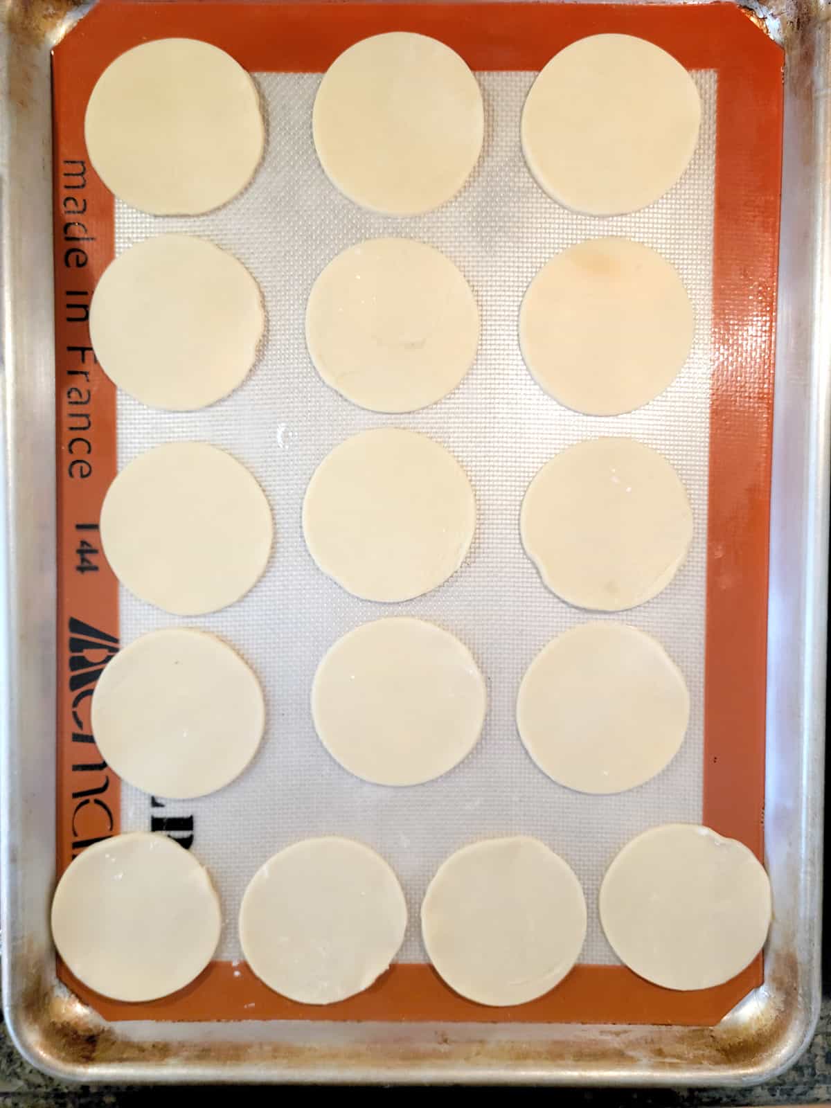 Pie crust rounds on a prepared baking sheet.