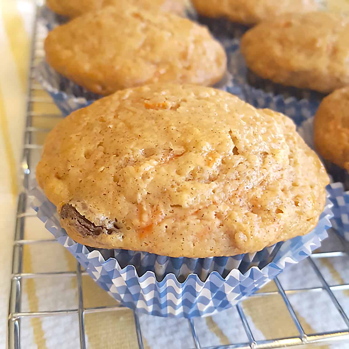 Carrot raisin muffins on a wire rack.