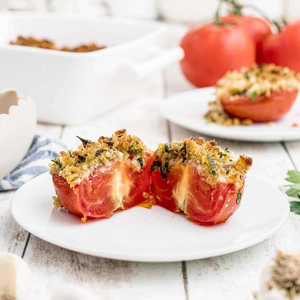 Finished tomatoes on a white serving dish.